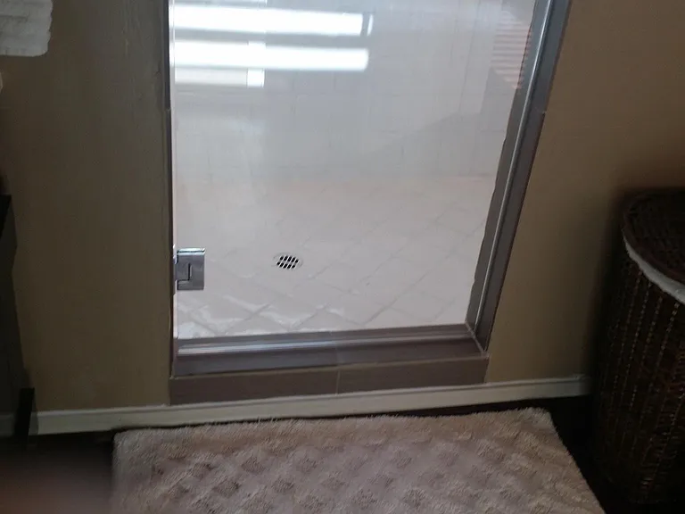 Shower room: bathroom mat and laundry basket included