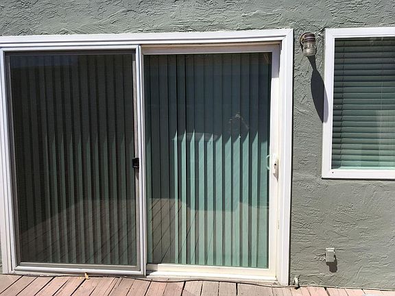 Back door to deck/patio area and car port.
