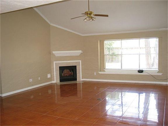 Den With Cathedral Ceiling and Corner Fireplace