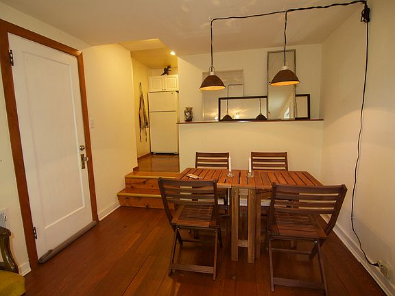 Living area from when the apartment was an Airbnb. Kitchen, bedroom and bath are up the two stairs.