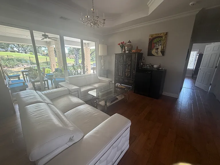 living room with patio door leading to patio and view of golf course