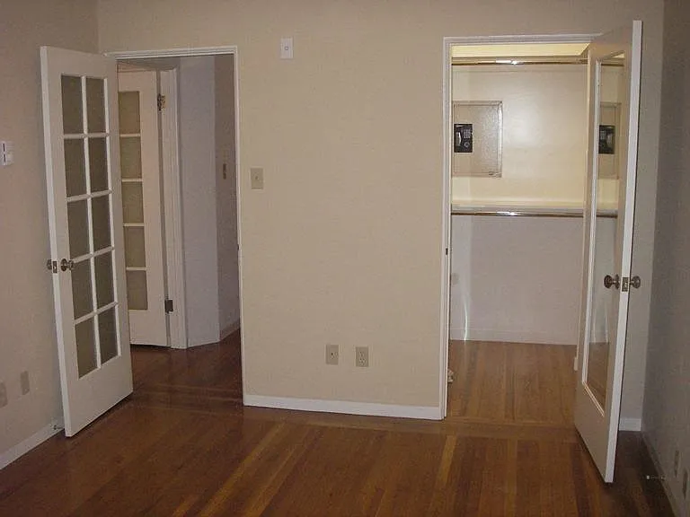 Bedroom with reorganized closet. Bay windows (6) behind the photograph.