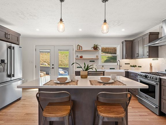 Kitchen with custom cabinets, 6 drawers in island, open shelving and pantry