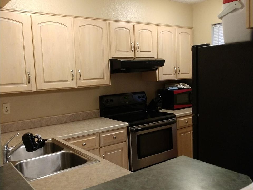 Stainless and black appliance theme. Small kitchen window out of view.