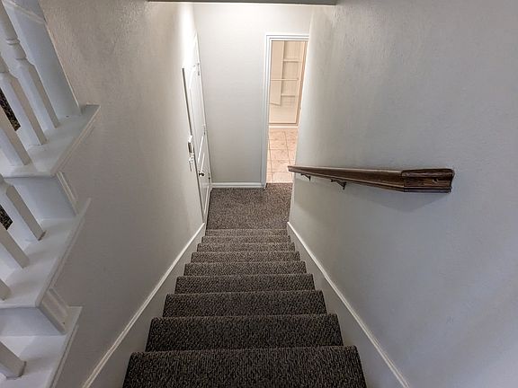 From stairway landing down to ground floor full bath and large flex room