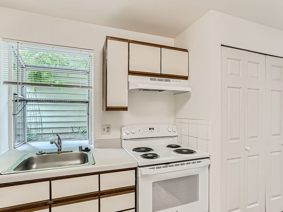 The kitchen has a garden window with great light for plants and herbs. The appliances include a newer range, a dishwasher, garbage disposal and a new refrigerator.