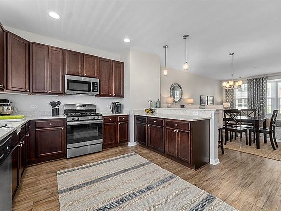 Beautiful Upgraded Kitchen with Granite countertops, Gas Stove, Stainless Steel appliances flowing into Dining area and Living room