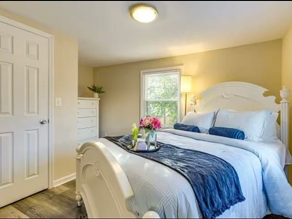 Bright second bedroom with two large windows for plenty of sunlight, blinds for shade and privacy, plus a spacious walk-in closet for all your storage needs.