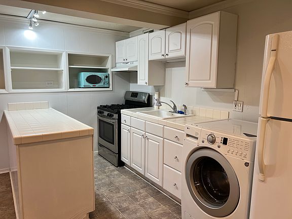 Kitchen has gas range oven microwave washer Refrigerator