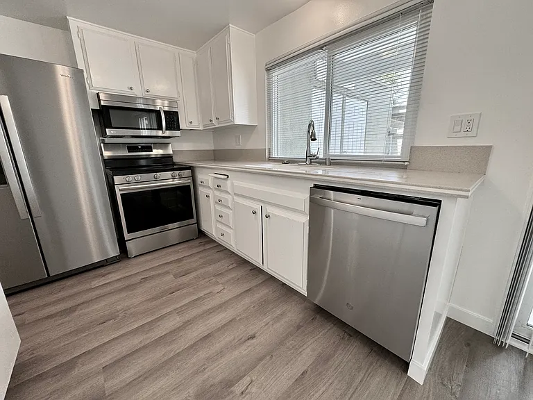 Light & Bright kitchen with new appliances (Refrigerator, Stove, Microwave & Dishwasher) new blinds, vinyl plank flooring and paint!