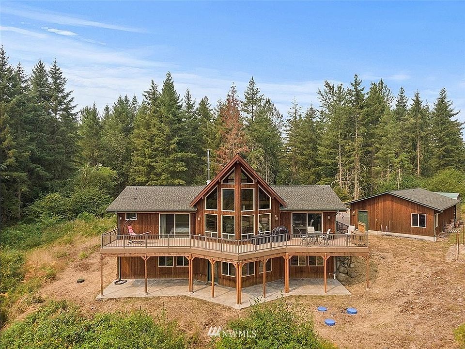 This beautiful home faces East and looks over acres of forest land with an unobstructed view of Mt. Rainier. Full top balcony & lower patio for plenty of entertaining space.