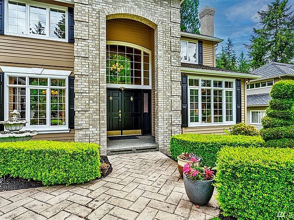 Custom Pavers Lead To The Covered, Two-Story Entryway With Double Doors And Leaded Glass. Welcome Home! New Exterior Paint In 2021.