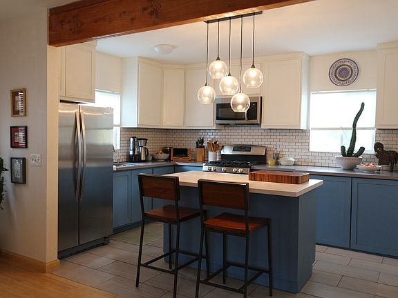 Kitchen includes an island, ceramic tile flooring ,refrigera