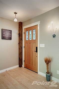 All new wood entry door with reclaimed wood beam accent