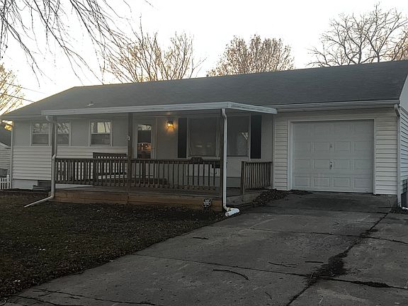 Front of home with large covered patio.