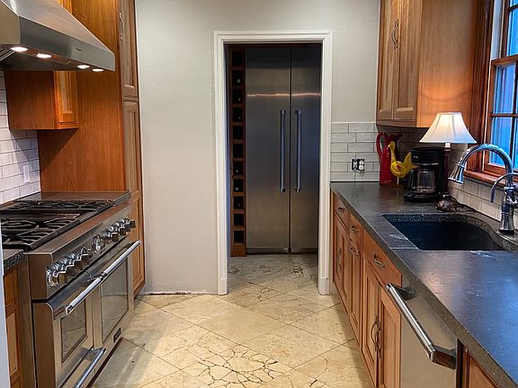 kitchen with cherry cabinetry & polished travertine floors