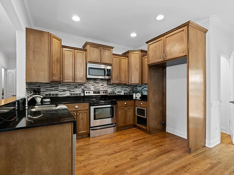 Kitchen with newer stainless steel refrigerator, new dishwasher and new convection stove/oven with air fryer.