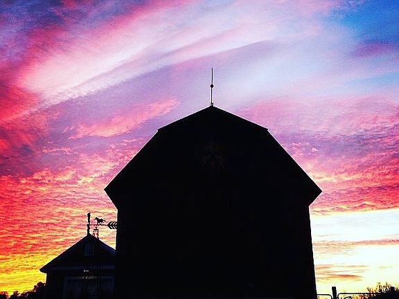 Sunrise over horse barn
