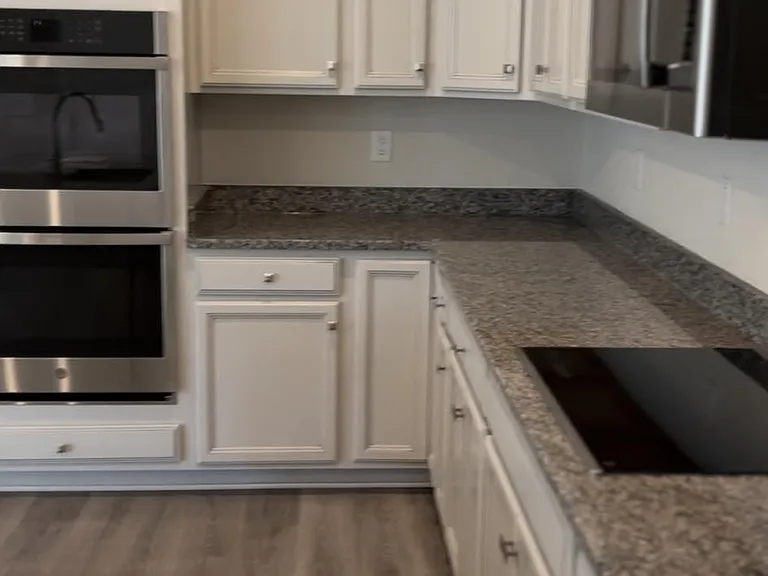 Gourmet kitchen with granite countertops and double wall oven.