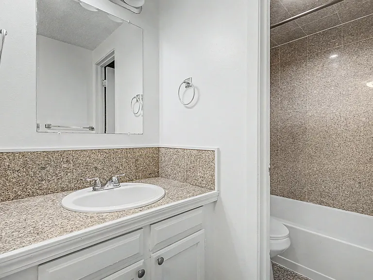 The sink locates outside of the bathroom for easy access and sharing.