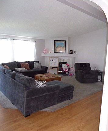 THIS IS A SUPER SPACIOUS AND BRIGHT LIVING ROOM WITH FIREPLACE
