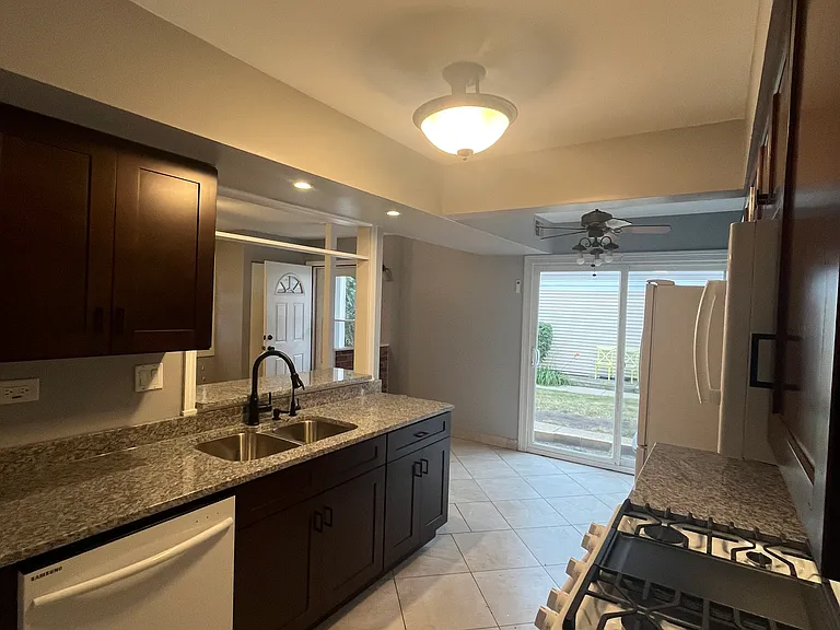 New range, microwave. galley style kitchen,