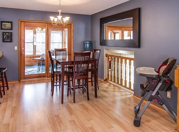 Formal dining area with access to sunroom and deck. Mirror included with home.