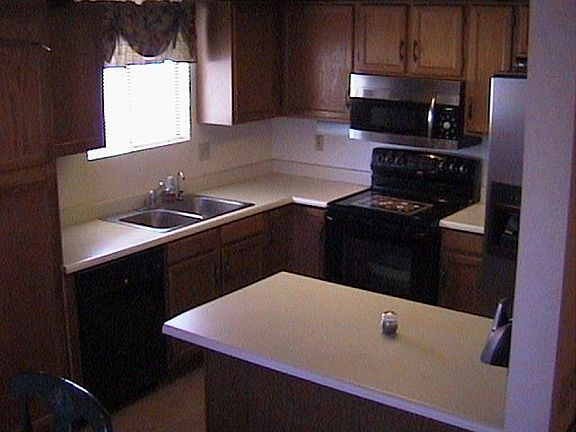 Kitchen looks into dining area, which looks into family room.