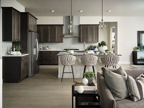 A modern and stylish kitchen with dark wood cabinets, a central island with plush upholstered stools