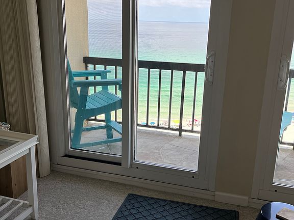 This is the balcony and a view of the Gulf from the balcony. The balcony is off of the living room.