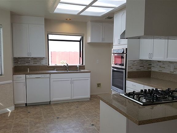 Kitchen with granite counter tops, tile back splash, gas cook top, oven, microwave, and breakfast nook (remodeled and all new November/December 2018).