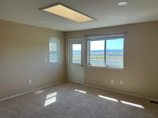 UPSTAIRS PRIMARY BEDRROM WITH PRIVATE DECK.