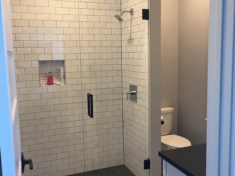 Slate-tiled bathroom with walk-in shower.