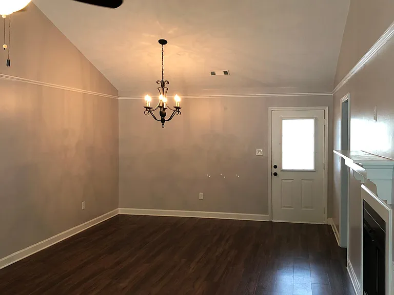 Great room with luxury vinyl plank and designer chandelier