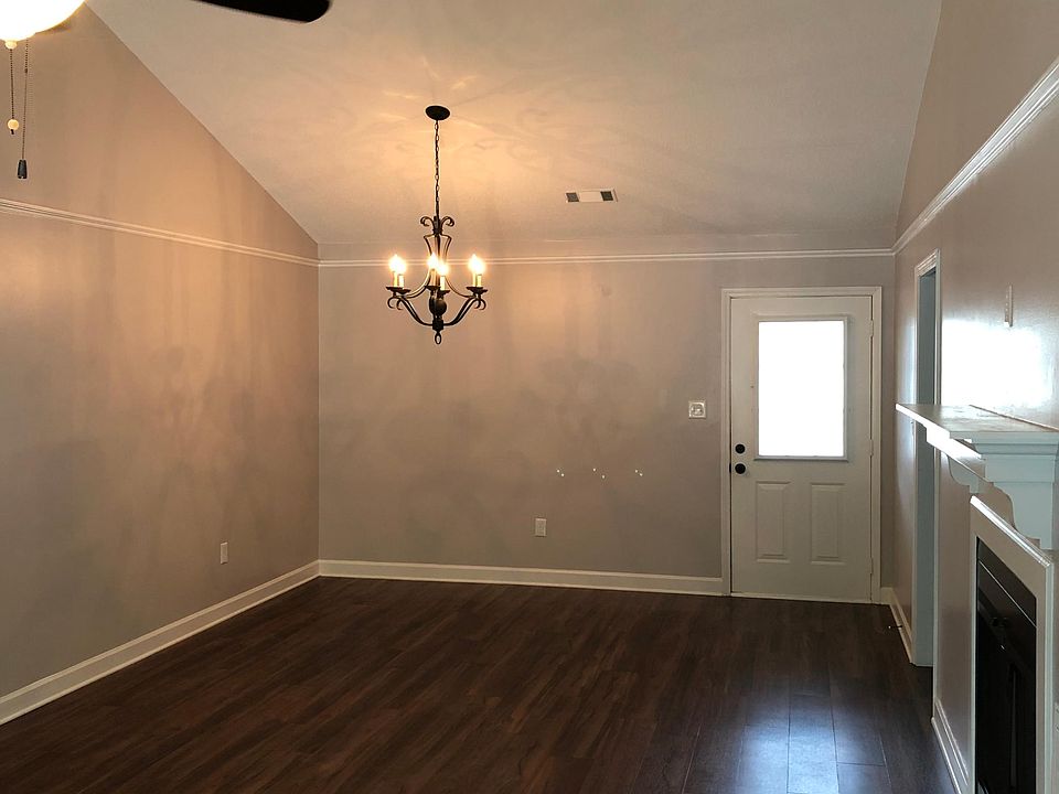 Great room with luxury vinyl plank and designer chandelier