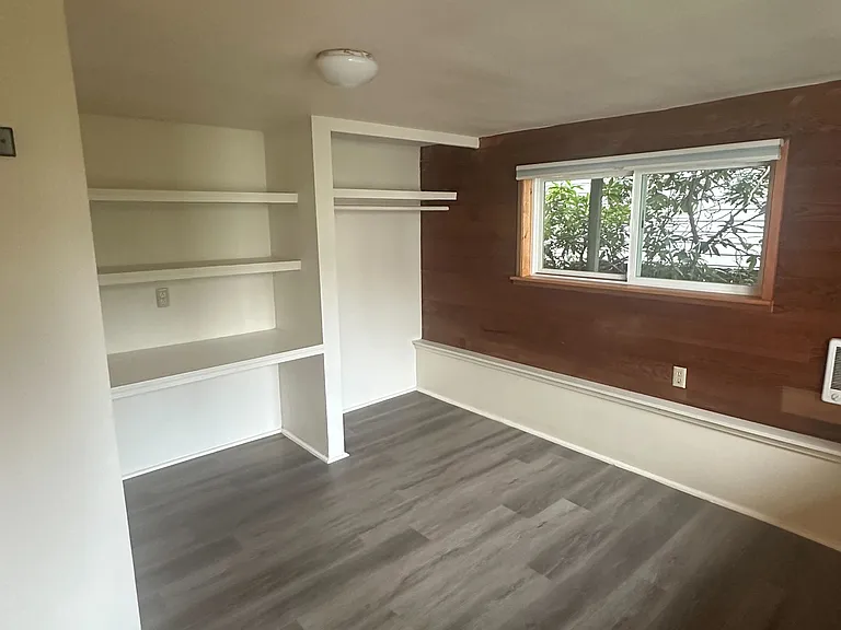 Front bedroom with abundant natural light. A favorite choice for a home office, with views of the private patio.