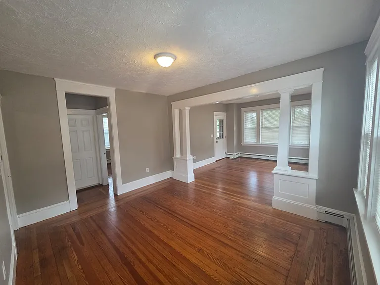 View from double parlor to bedroom 3 and bathroom, and front entrance door and balcony