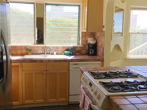 Cozy kitchen with stove, oven, microwave, dishwasher, garbage disposal, washer/dryer stackable unit