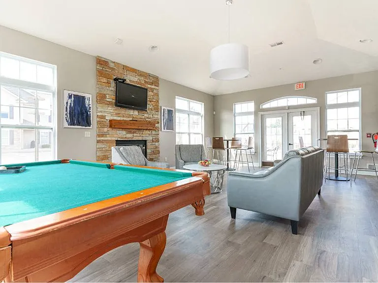 Lehigh Park Community Center with pool table, fireplace, flat screen tv, seating area, and high-top tables