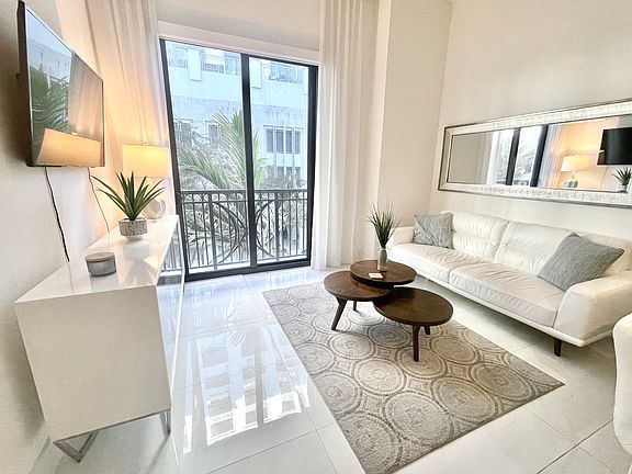 Confortable leather sofa with accent pillows and lush area rug