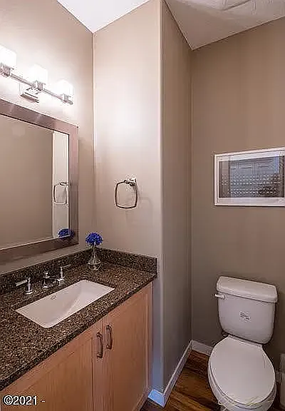Main Level Half Bathroom with Quartz Counters and Kohler Sink and Fixture