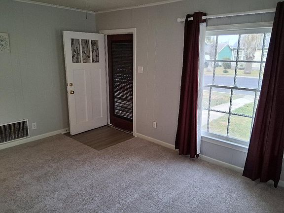 This is the living room with the front door facing Alcoa. The living room is 12x16 with an open concept leading to the dining area and kitchen.