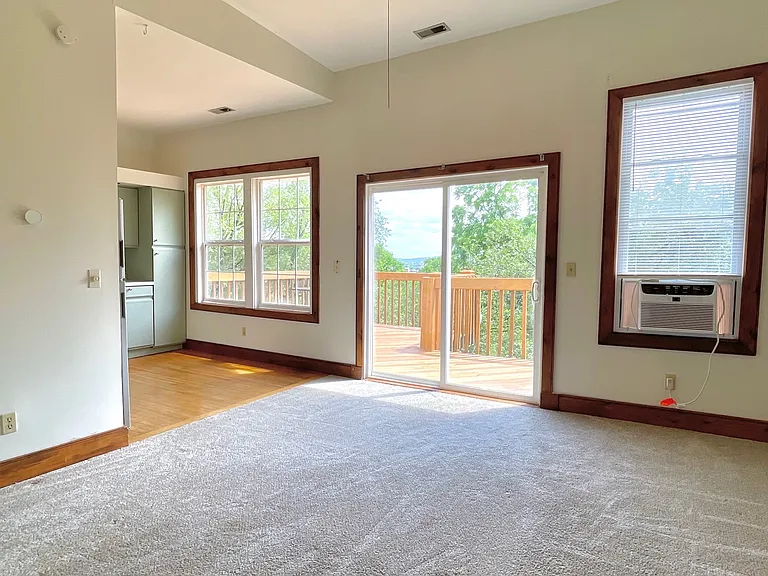Note, older photo. All trim has been updated to white and carpet replaced with wood laminate floors.