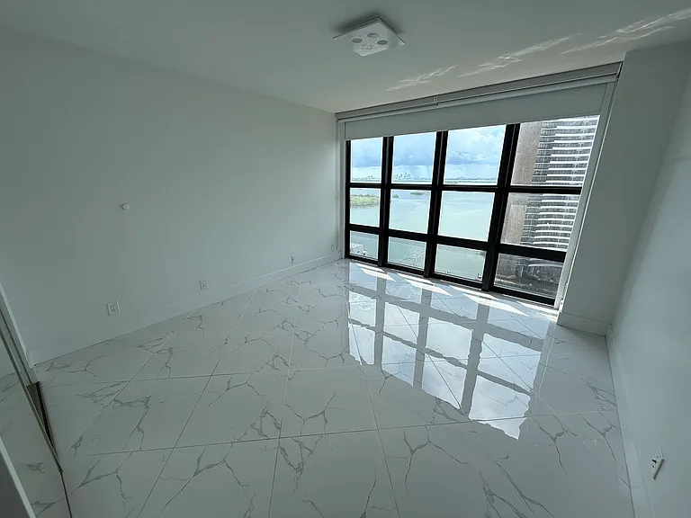 GUEST BEDROOM or OFFICE with dimmable designer lighting, full wall mirror, floor-to-ceiling impact windows, electric blackout curtain, zebra shades & large closet system