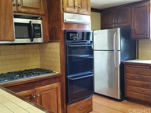 Big open kitchen with newer stainless fridge and microwave,