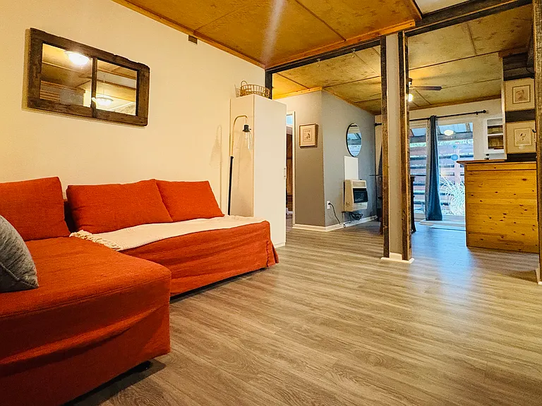 Image looking into apartment studio after walking through front door. Showcasing brand new laminate flooring.