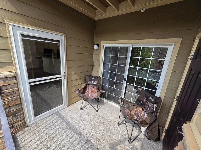 Balcony off the living room, with outdoor storage, and access to guest bedroom