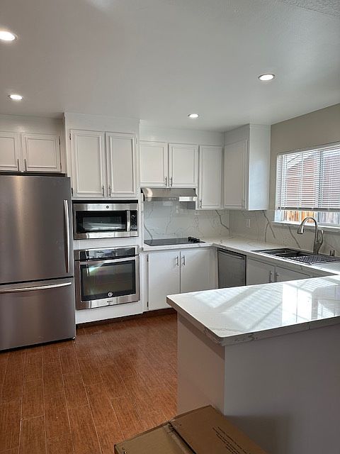 KItchen with new stainless steel refrigerator with bottom freezer,
new microwave/air fryer, new exhaust fan, new induction range, new LED lights, double pane windows, new countertop(porcelain)