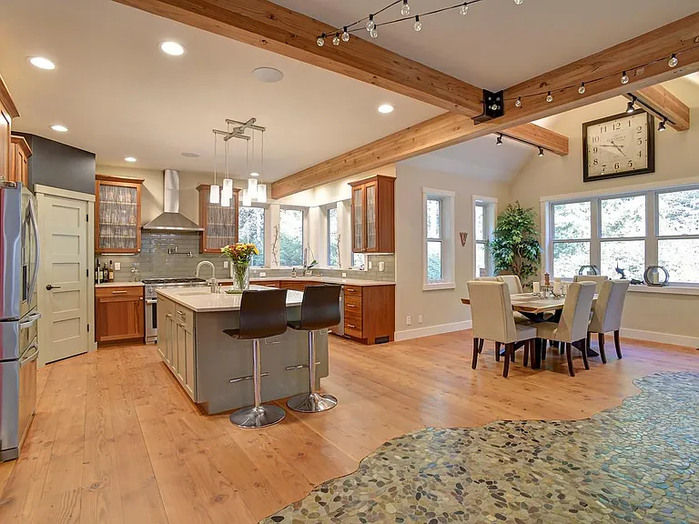 The dining room is located off the kitchen as well as there's seating at the large island. The live edge wood dining table comfortably seat 6 people.
