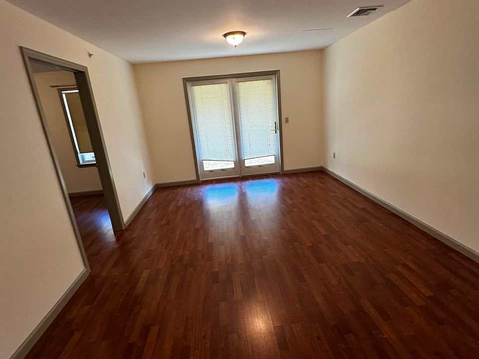 Large living room area with gleaming hardwood floors